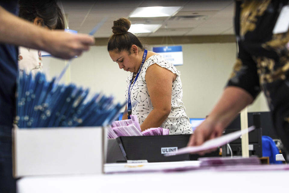 County workers check mails in ballots. Nevada conducting its primary election. (Ty O'Neil /  SOPA Images/Sipa USA via AP file)