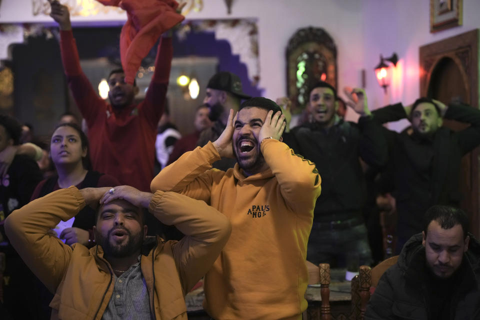 Morocco fans react as they watch the semifinal match against France in the World Cup, in Barcelona, Spain Wednesday, Dec. 14, 2022. (AP Photo/Emilio Morenatti)