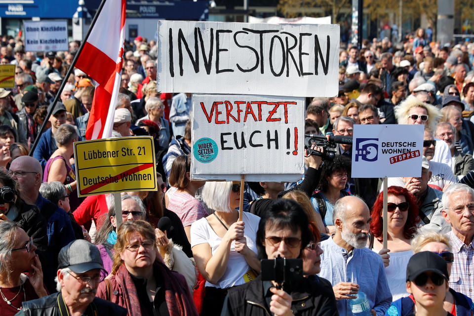 People hold placards reading ‘Investors get out!’ at a protest march against rising rents and a housing shortage in Berlin, Germany. Photo: Fabrizio Bensch/Reuters