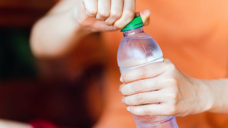 Person opening a bottle of water