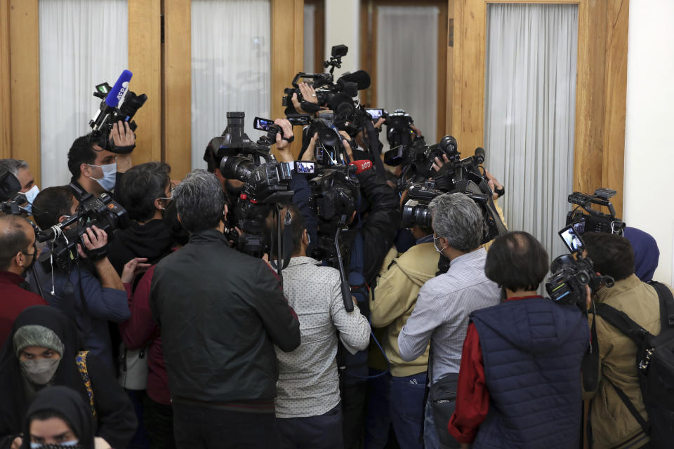 Journalists try to enter the room where the head of the International Atomic Energy Agency, IAEA, Rafael Mariano Grossi and Iranian Foreign Minister Hossein Amirabdollahian are meeting, in Tehran, Iran, Tuesday, Nov. 23, 2021. The head of the United Nations' atomic watchdog met Tuesday with Iranian officials to press for greater access in the Islamic Republic ahead of diplomatic talks restarting over Tehran's tattered nuclear deal with world powers. (AP Photo/Vahid Salemi)