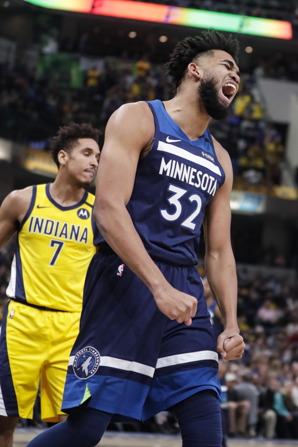 Minnesota Timberwolves center Karl-Anthony Towns (32) reacts after being fouled during the first half of the team's NBA basketball game against the Indiana Pacers in Indianapolis, Friday, Jan. 17, 2020. (AP Photo/Michael Conroy)