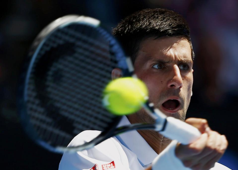 Novak Djokovic of Serbia hits a return to Andrey Kuznetsov of Russia during their men's singles second round match at the Australian Open 2015 tennis tournament in Melbourne January 22, 2015. REUTERS/Issei Kato (AUSTRALIA - Tags: SPORT TENNIS)