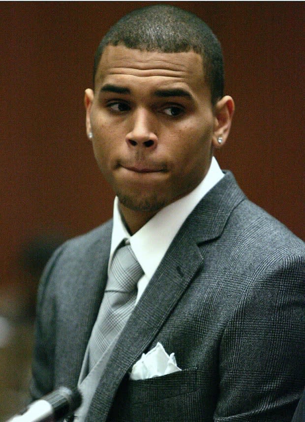 Chris Brown listens to the court proceedings as he is arraigned on assault charges in the Los Angeles Superior Court on March 5, 2009. Brown was charged with assaulting his pop star girlfriend Rihanna as gruesome details about the alleged attack emerged for the first time.<p><a href="https://www.gettyimages.com/detail/85266040" rel="nofollow noopener" target="_blank" data-ylk="slk:AFP/Getty Images;elm:context_link;itc:0;sec:content-canvas" class="link ">AFP/Getty Images</a></p>