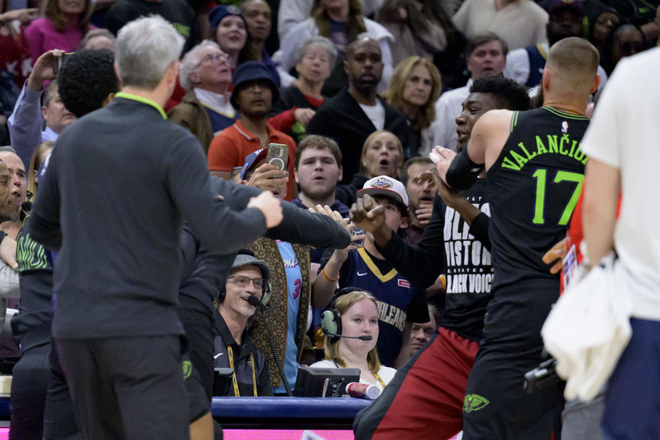 Miami Heat center Thomas Bryant, right, is held back by New Orleans Pelicans center Jonas Valanciunas (17) after getting in a scuffle with New Orleans Pelicans guard Jose Alvarado (obscured) during the second half of an NBA basketball game in New Orleans, Friday, Feb. 23, 2024. Alvarado and Bryant were ejected from the game. (AP Photo/Matthew Hinton)