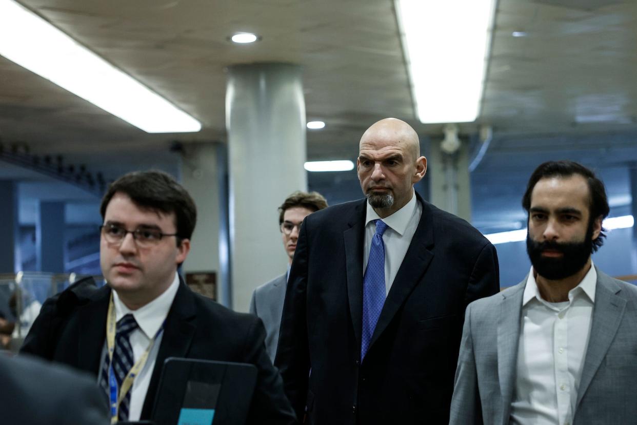 Democratic Sen. John Fetterman of Pennsylvania (C) walks to a classified briefing on Capitol Hill with his senior advisor Bobby Maggio (L) and spokesman Joe Calvello (R) on February 14, 2023 in Washington, DC.