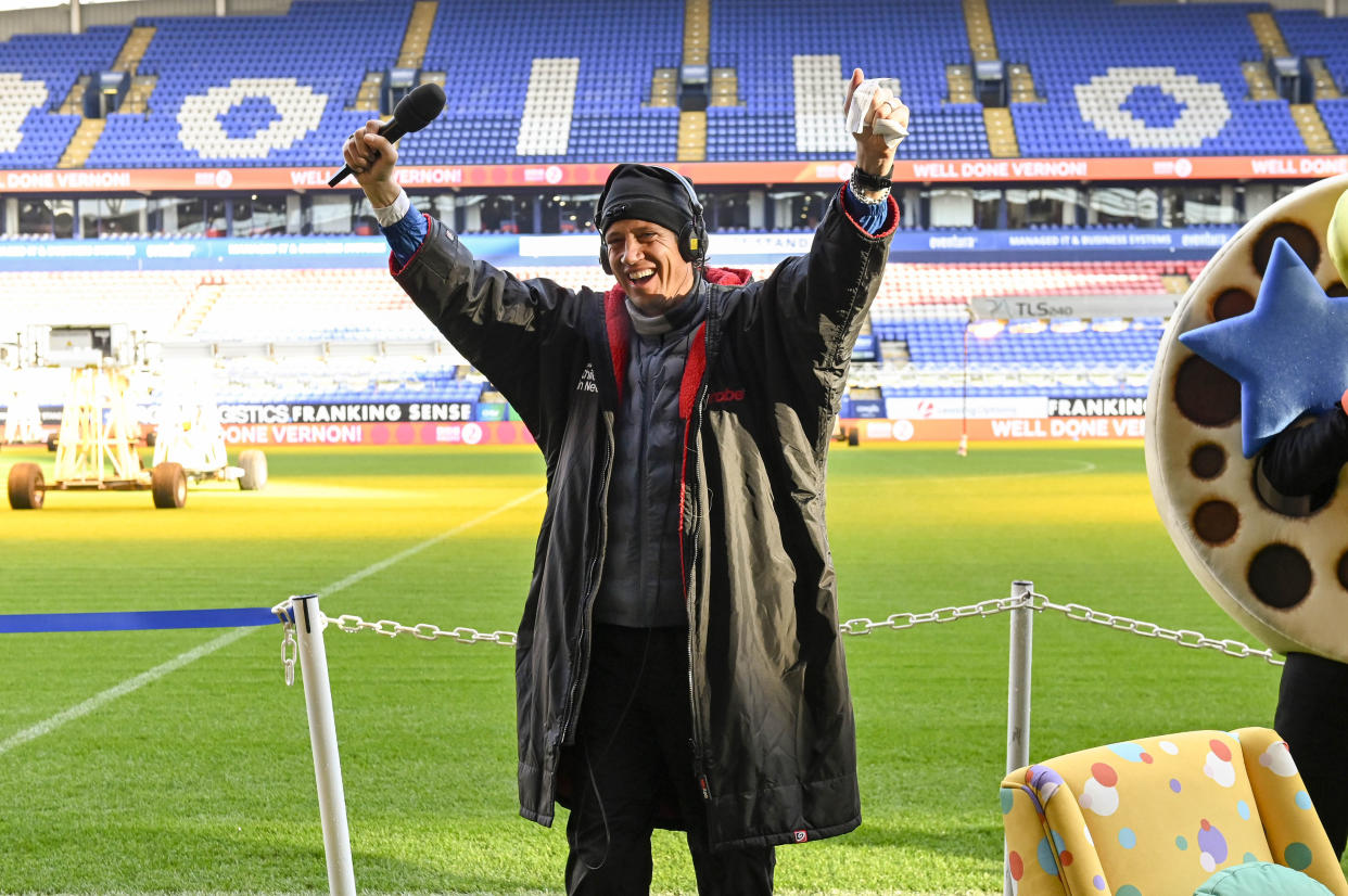 Vernon Kay raises his arms after completing an ultra-marathon