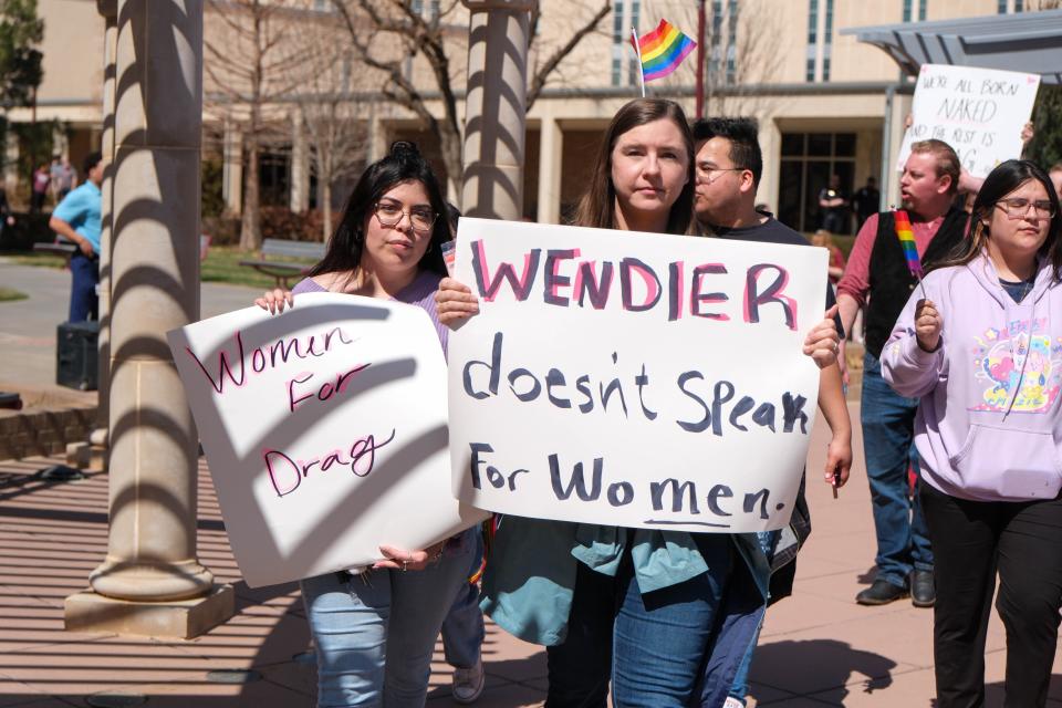 A West Texas A&M University student holds up a sign Tuesday responding to the university's president canceling an on-campus drag show in Canyon. WT President Walter Wender said in a memo to the university community that he opposes the drag show as a dimishment toward women.