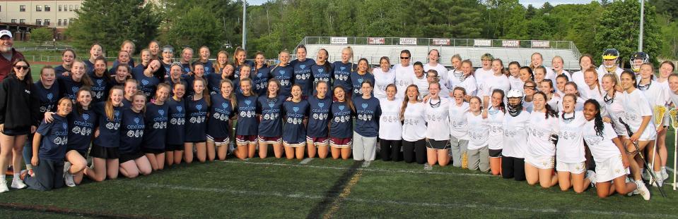 Members of the girls lacrosse teams from Portsmouth, left, and Souhegan came together Thursday night in support of the One Love Foundation at Tom Daubney Field.