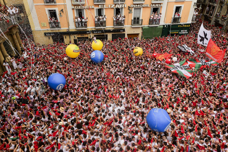 Revellers dressed in red and white fill the town hall square during the 'Chupinazo' rocket, to mark the official opening of the 2023 San Fermín fiestas in Pamplona, Spain, Thursday, July 6, 2023. (AP Photo/Alvaro Barrientos)