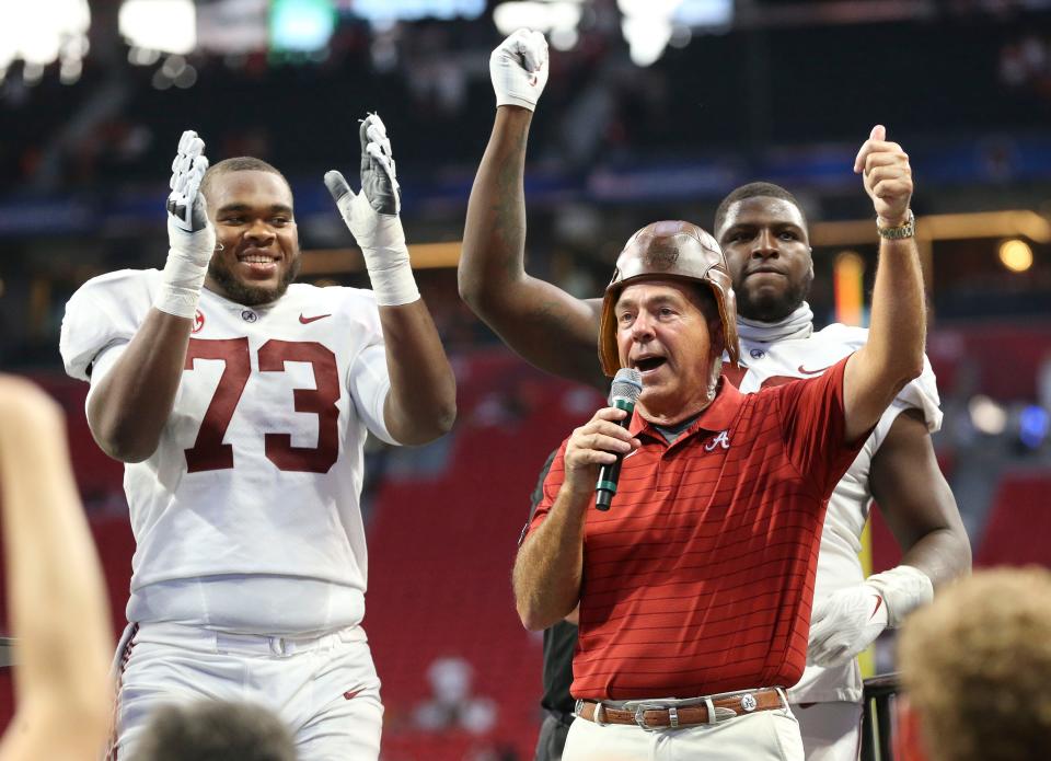 Sep 4, 2021; Atlanta, Georgia, USA;  Alabama Head Coach Nick Saban celebrates the Alabama win with Alabama offensive lineman Evan Neal (73) and Alabama defensive lineman Phidarian Mathis (48) at Mercedes-Benz Stadium. Alabama defeated Miami 44-13. Mandatory Credit: Gary Cosby-USA TODAY Sports