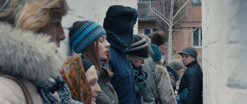 People line up in war-ravaged eastern Ukraine in the movie "Donbass."