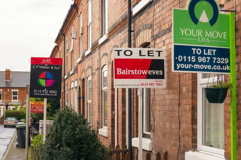 Nottingham, UK - March 26, 2014: Several property agency signs posted outside terraced houses in Beeston in the East Midlands city of Nottingham, England.