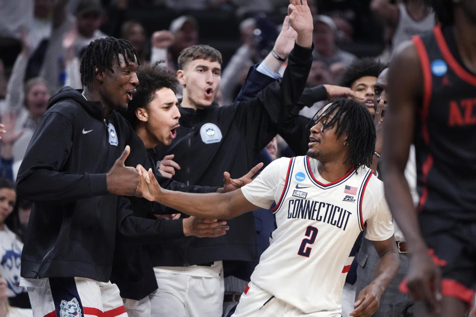 UConn guard Tristen Newton (2) celebrates with teammates while pulling away from San Diego State during the second half of the Sweet 16 college basketball game in the men's NCAA Tournament, Thursday, March 28, 2024, in Boston. (AP Photo/Michael Dwyer)