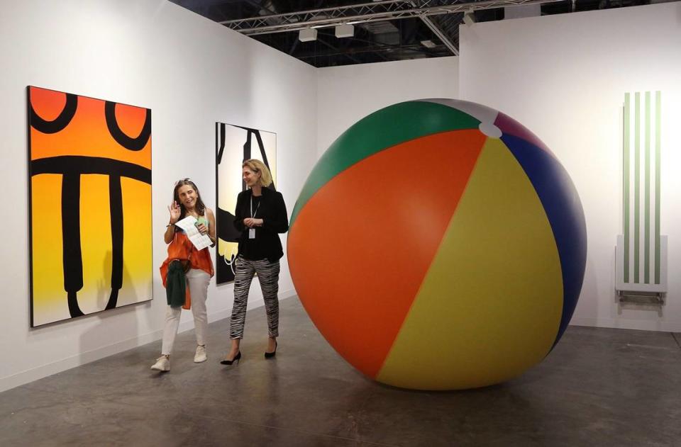 On Wednesday, Fusun Eczacibasi,left, tours the booth of Nicolai Wallner of Copenhagen with art agent, Gitte Sjkodt Madsen, right, at booth during the VIP opener at Art Basel.