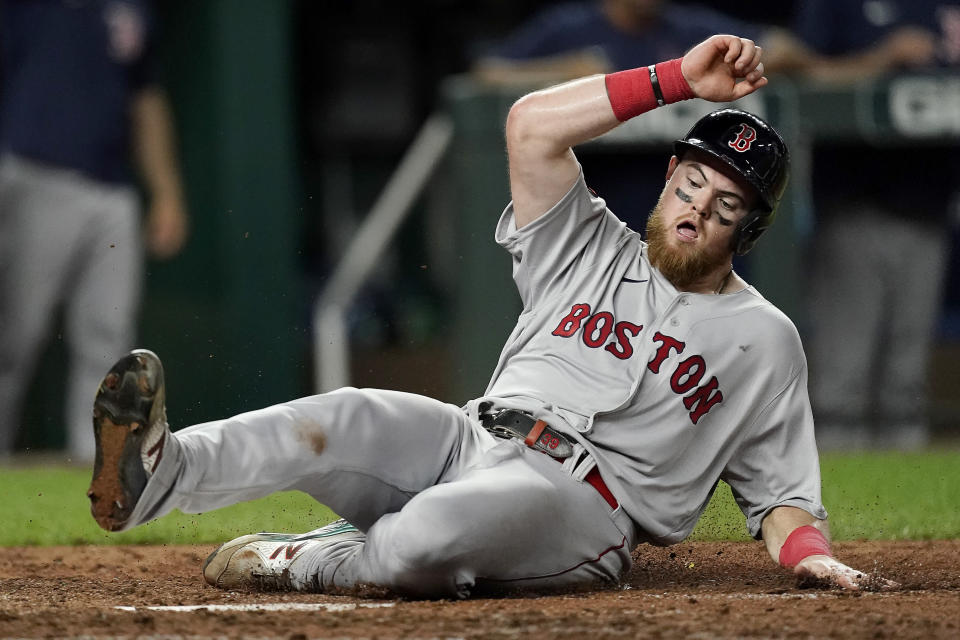 Boston Red Sox's Christian Arroyo slides home to score on a single by Kevin Plawecki during the seventh inning of a baseball game against the Kansas City Royals Thursday, Aug. 4, 2022, in Kansas City, Mo. (AP Photo/Charlie Riedel)