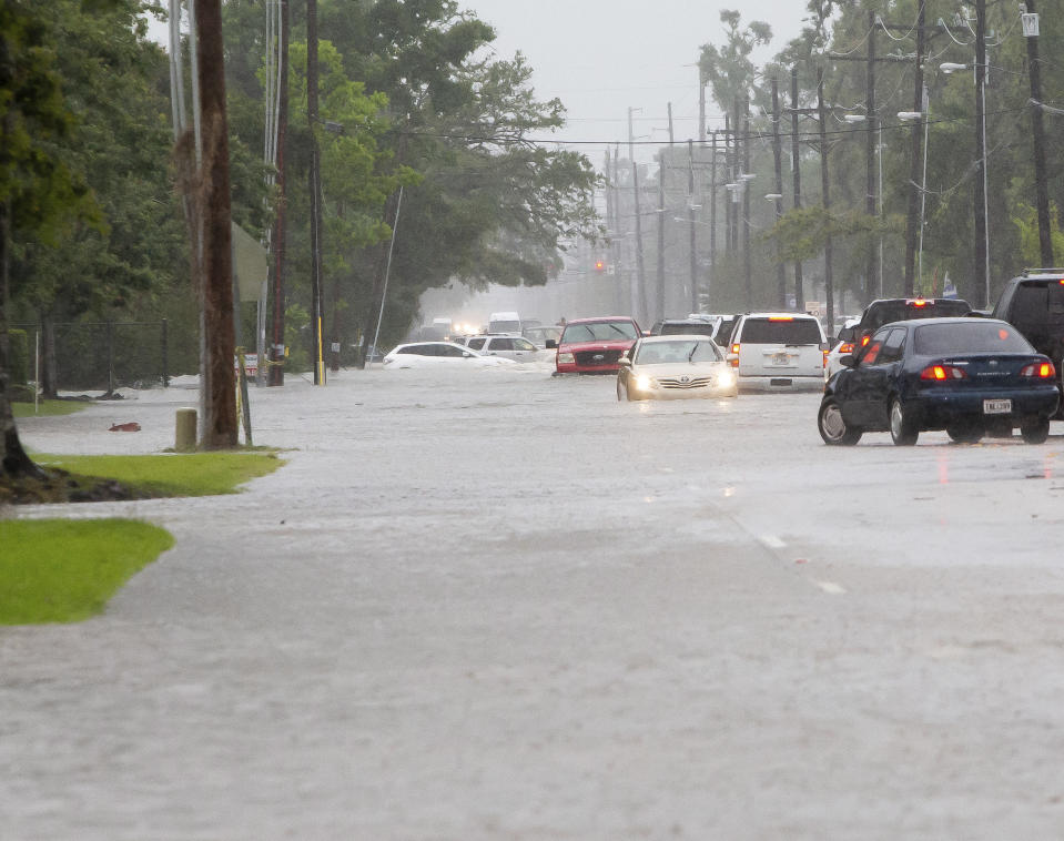 Cars sit stalled on a flooded McNeese Street during heavy rains in Lake Charles, La., Monday, May 17, 2021. (Rick Hickman/American Press via AP)