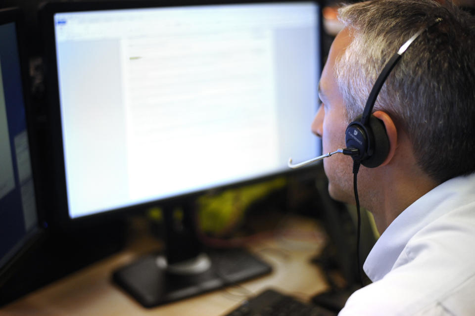 PICTURE POSED BY MODEL A generic stock photo of an office worker using a hands free headset .