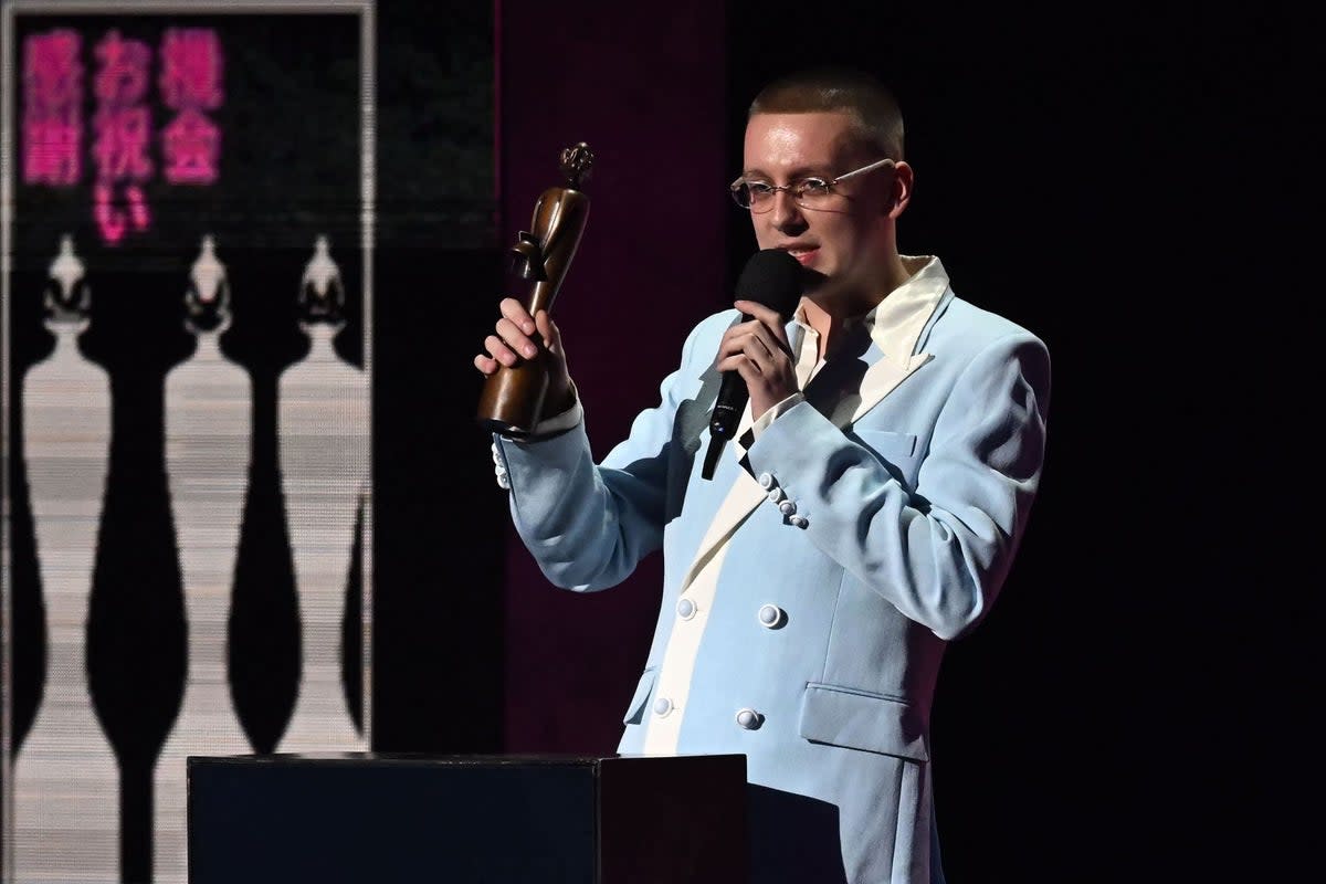 British rapper Aitch celebrates after receiving the best hip hop, grim and rap act of the year award (AFP/Getty)