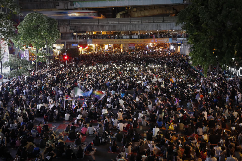 Pro-democracy activists wave their mobile phone with flashing lights during a protest rally at Ratchaprasong business district in Bangkok, Thailand, Sunday, Oct. 25, 2020. Pro-democracy protesters in Thailand gathered again on Sunday in Bangkok, seeking to keep up pressure on the government a day ahead of a special session of Parliament called to try to ease political tensions. (AP Photo/Gemunu Amarasinghe)