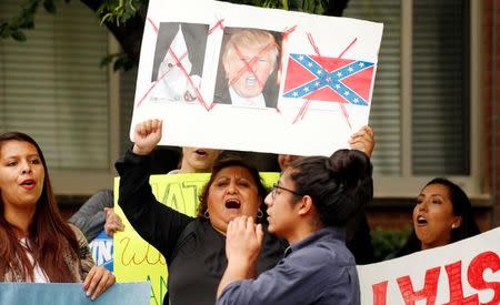 Protesters shout outside the Republican National Committee where Trump was meeting Speaker of the House Paul Ryan on Capitol Hill in Washington May 12, 2016. REUTERS/Kevin Lamarque