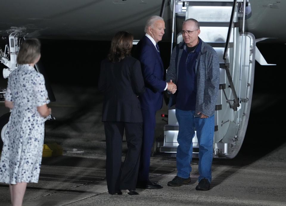 Paul Whelan shaking hands with President Joe Biden after disembarking the plane at Joint Base Andrews.