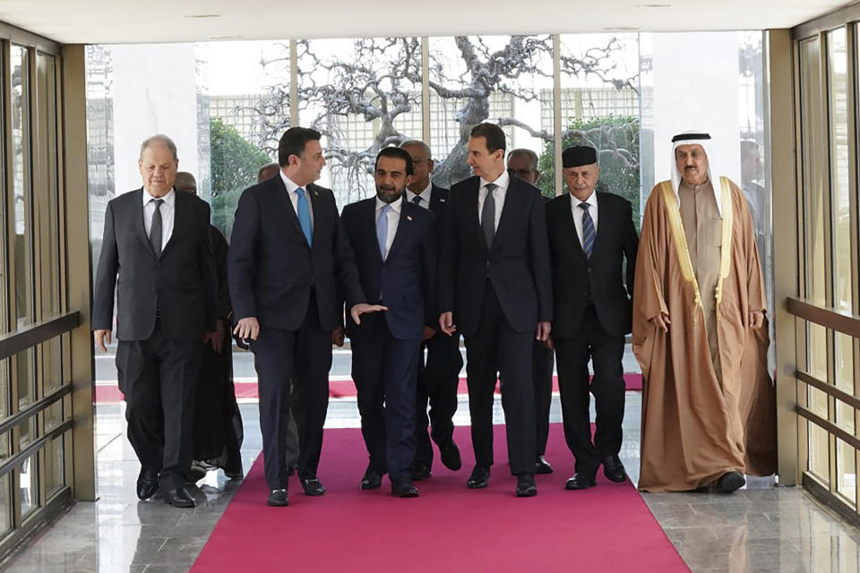 In this photo released by the official Telegram account of the Syrian Presidency, Syrian President Bashar Assad, third right, meets with a delegation representing various Arab parliaments in Damascus, Sunday, Feb. 26, 2023. (Syrian Presidency via Telegram via AP)