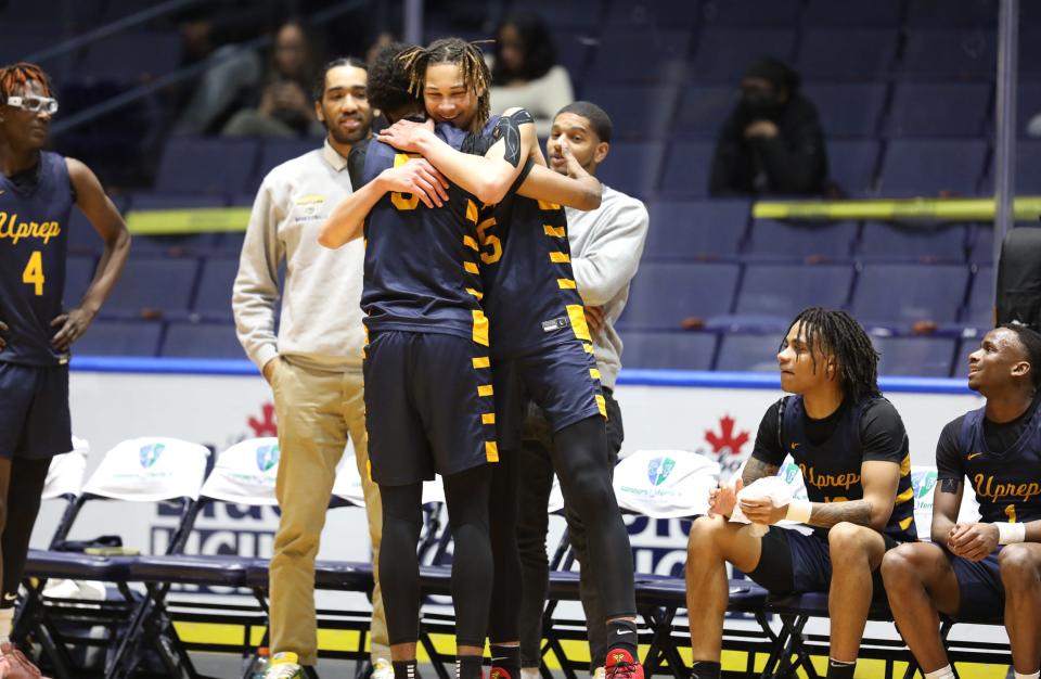 UPrep's Knekose Mack hugs teammate Keone Manigault in the final seconds of the game. UPrep won 83-65 against Franklin at Blue Cross Arena.