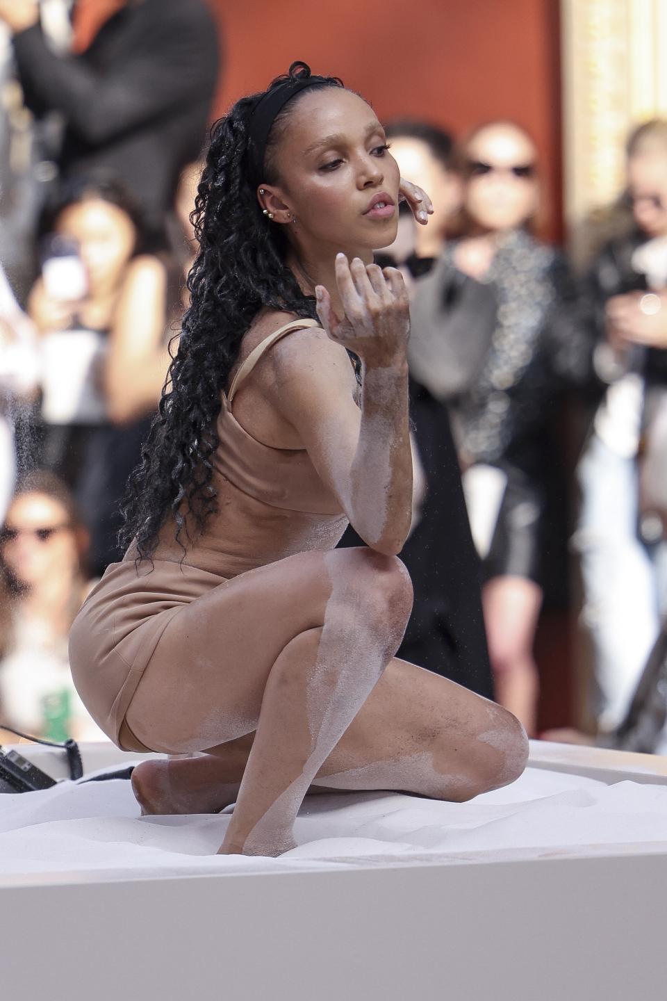 FKA twigs performs during the Valentino Spring/Summer 2024 womenswear fashion collection presented Sunday, Oct. 1, 2023 in Paris. (AP Photo/Vianney Le Caer)