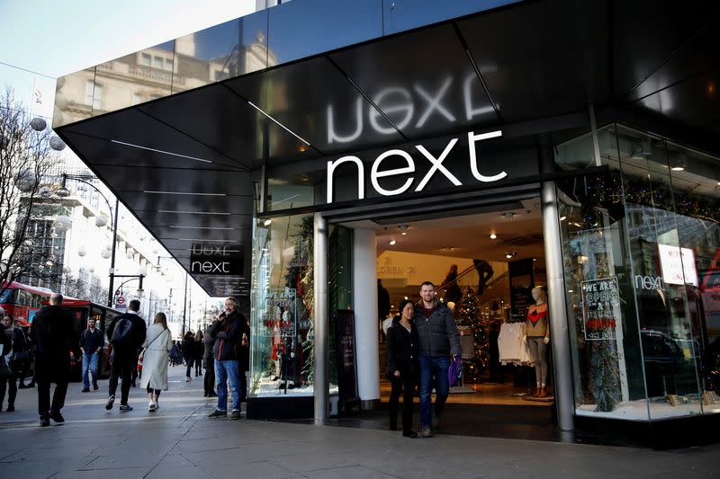 FILE PHOTO: Shoppers walk past a Next store on Oxford Street in London