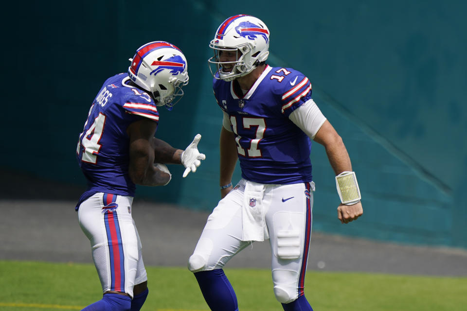 Buffalo Bills quarterback Josh Allen (17) celebrates with wide receiver Stefon Diggs (14) after Diggs scored a touchdown during the first half of an NFL football game against the Miami Dolphins, Sunday, Sept. 20, 2020 in Miami Gardens, Fla. (AP Photo/Wilfredo Lee)