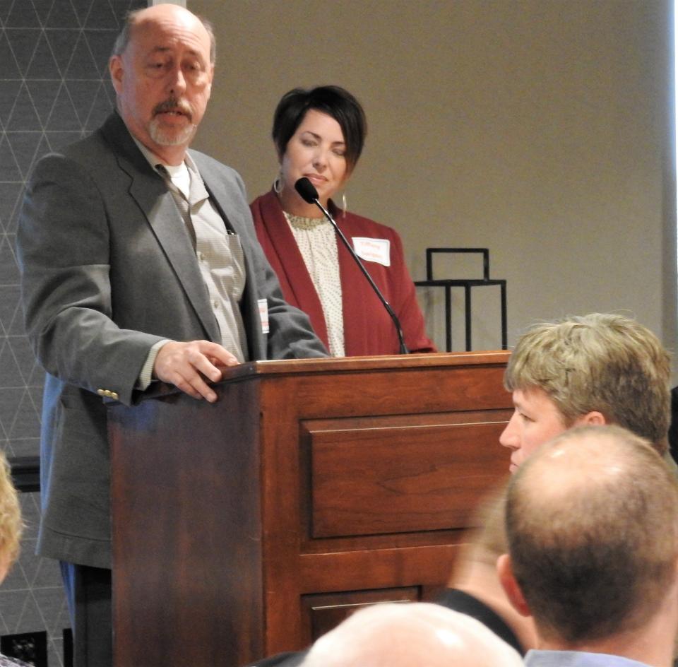 Paul Bratton of MFM Building Products, with Tiffany Swigert of the Coshocton Port Authority looking on, accepts the Small Manufacturer Excellence Award from the Easter Ohio Development Alliance during its recent annual meeting in Walnut Creek. MFM recently completed a new warehouse and added a product line in its main building.