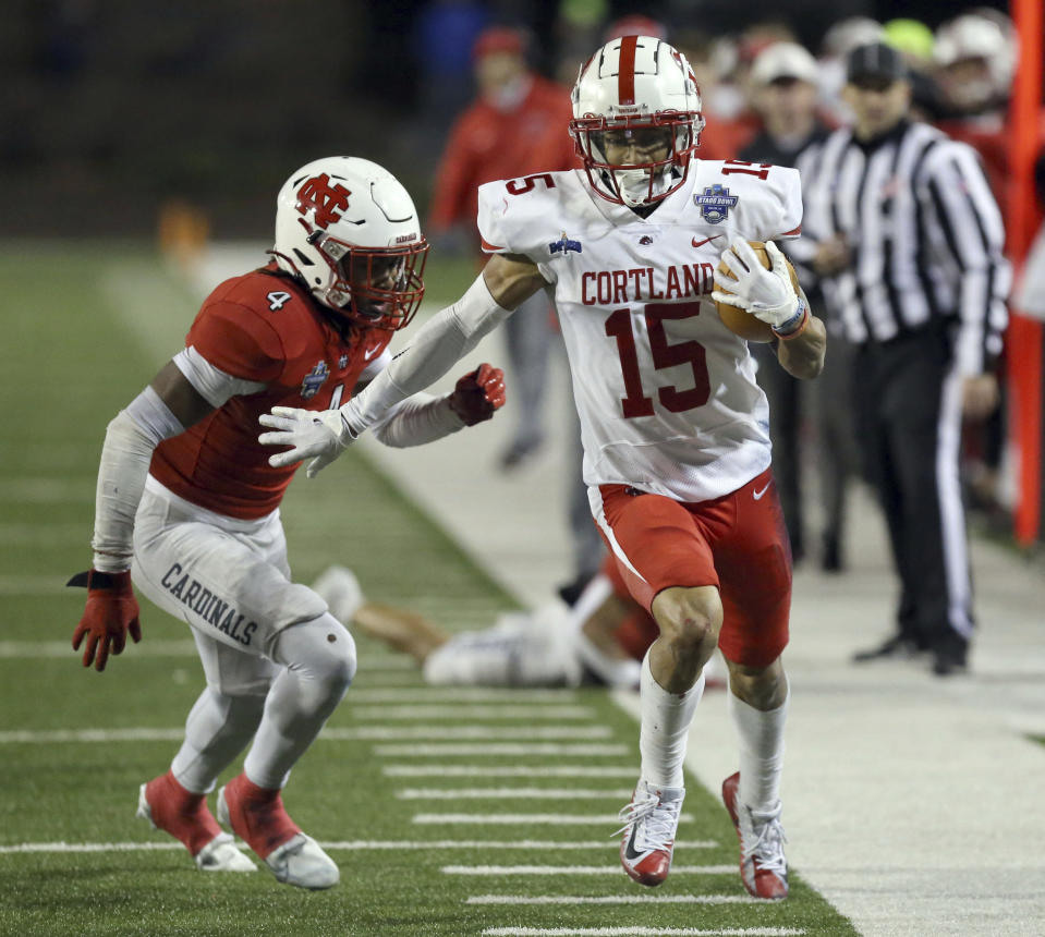 Cortland's Cole Burgess (15) runs for a touchdown past North Central's Kyler Green (4) during the second half of the Amos Alonzo Stagg Bowl NCAA Division III championship football game in Salem, Va., Friday Dec. 15, 2023. (Matt Gentry/The Roanoke Times via AP)