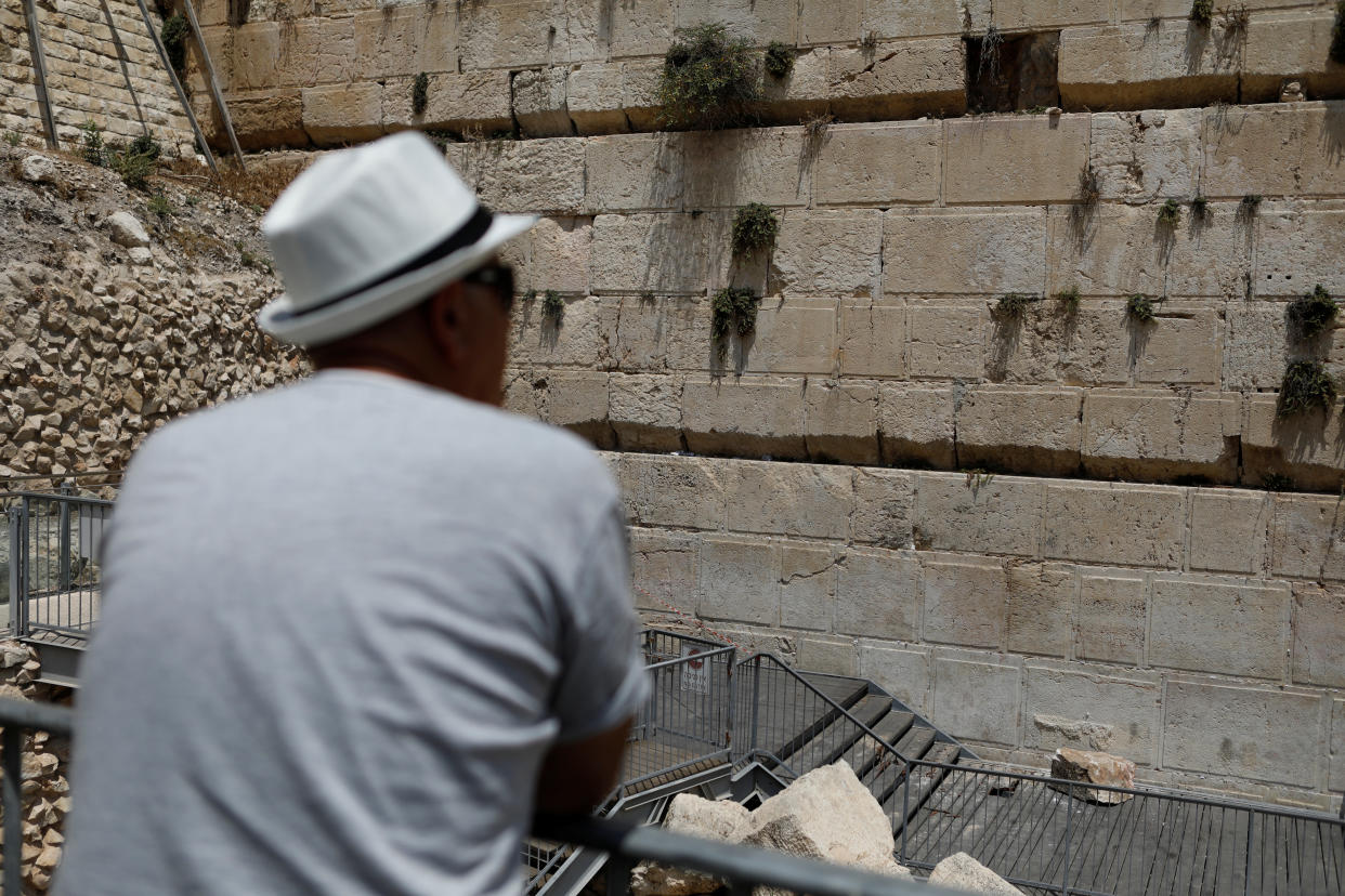 A man looks at the stone that fell from the Western Wall on Monday.