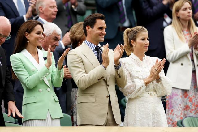 Princess Kate gives Wimbledon champion Roger Federer a lengthy standing  ovation at the All England Club