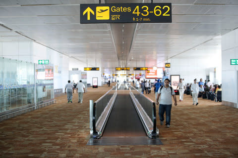 A boarding gate sign at Delhi airport in India - Credit: Getty