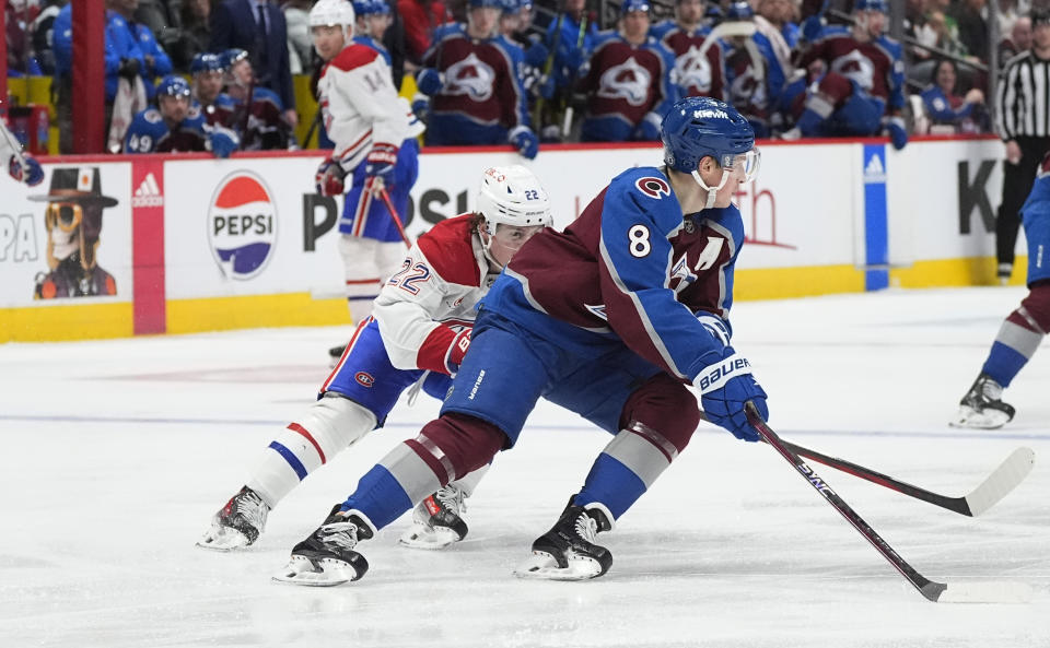 Colorado Avalanche defenseman Cale Makar, front, collects the puck as Montreal Canadiens right wing Cole Caufield pursues in the second period of an NHL hockey game Tuesday, March 26, 2024, in Denver. (AP Photo/David Zalubowski)