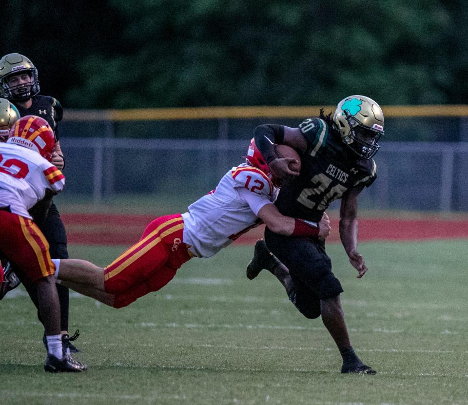 Clearwater Central Catholic's Carson Schiavello tries to bring down Trinity Catholic's Beau Beard (20) in the first half of their game in Ocala on Friday, Sept. 2, 2022.