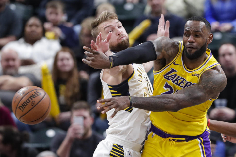 Los Angeles Lakers forward LeBron James (23) makes a pass in front of Indiana Pacers forward Domantas Sabonis (11) during the second half of an NBA basketball game in Indianapolis, Tuesday, Dec. 17, 2019. The Pacers defeated the Lakers 105-102. (AP Photo/Michael Conroy)