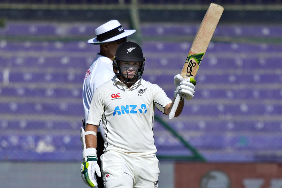 New Zealand's Tom Latham celebrates after scoring 50 runs during the first day of the second test cricket match between Pakistan and New Zealand, in Karachi, Pakistan, Monday, Jan. 2, 2023. (AP Photo/Fareed Khan)