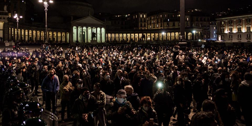 Citizens together with shopkeepers protest in Piazza Plebiscito against the anti-Covid restrictions imposed by the Italian Government of Giuseppe Conte and the Regional Council of Governor Vincenzo De Luca, to limit the spread of the Covid-19 virus, in Naples, Italy, on 26 October 2020. After the last Dpcm of Giuseppe Conte's Italian Government, which establishes the closure of various commercial activities (gyms, cinemas, theatres, amusement arcades, wellness centres) and the closure at 6pm for restaurants, pubs and coffebars, until November 24th, bringing a series of protests and disapproval in many Italian squares by citizens and traders due to the loss of job opportunities. (Photo by Manuel Dorati/NurPhoto via Getty Images)