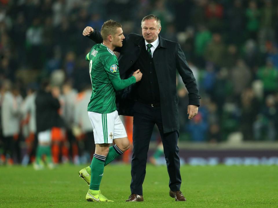 Northern Ireland's Steven Davis with manager Michael O'Neill: PA