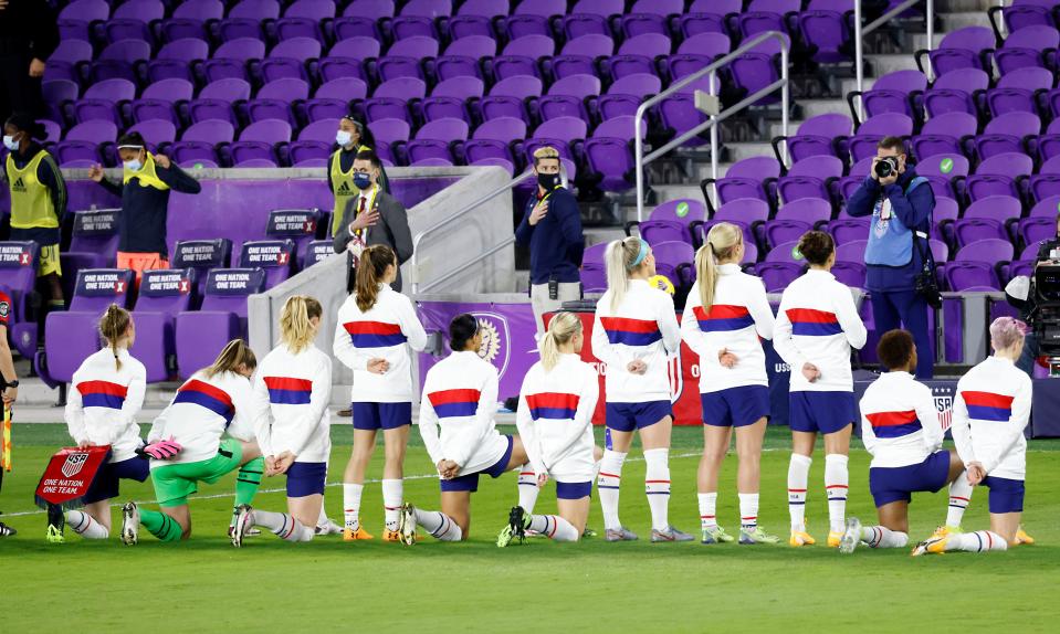 Several United States players take a knee during the national anthem before their match against Colombia in January.