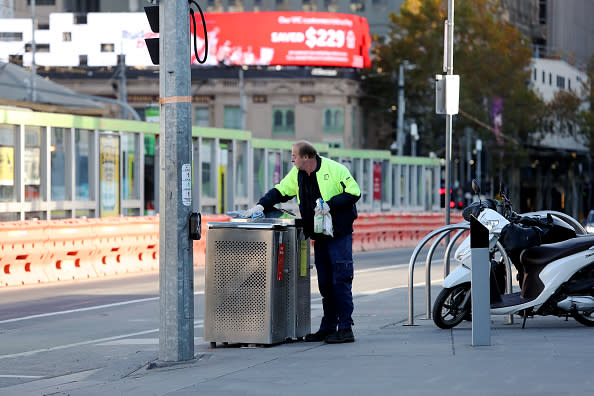 A man from a city cleaning crew tasked with sanitising public surfaces is seen in the Melbourne CBD.
