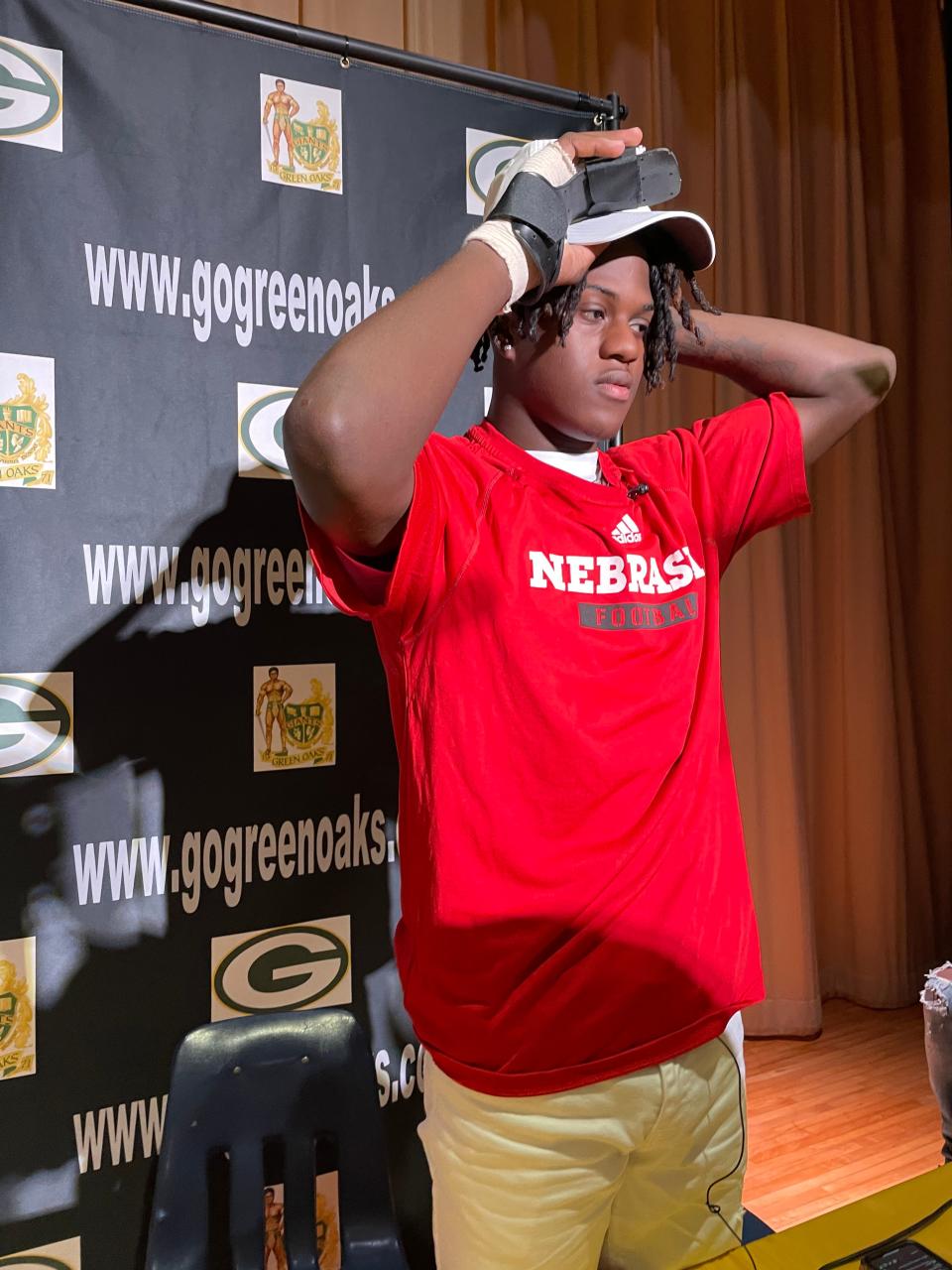 Green Oaks wide receiver De'Coldest Crawford dons a Nebraska hat during a Friday morning ceremony at the school where he signed with the Cornhuskers.
