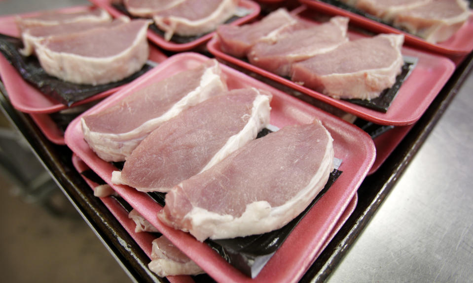 FILE - This March 3, 2011 file photo shows boneless pork loins waiting to be packaged at a local Dahl's grocery store in Des Moines, Iowa. The American meat industry is rolling out a refresh of the often confusing 40-year-old system used for naming the various cuts of beef, pork, lamb and veal. That's because the system was designed more for the needs of retailers and butchers than for the convenience of harried shoppers more familiar with Shake 'n Bake than boneless shank cuts. (AP Photo/Charlie Neibergall, file)