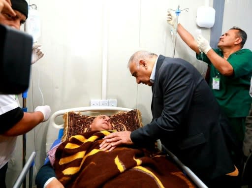 Iraqi Prime Minister Adel Abdel Mahdi visits survivors of the ferry disaster at a Mosul hospital