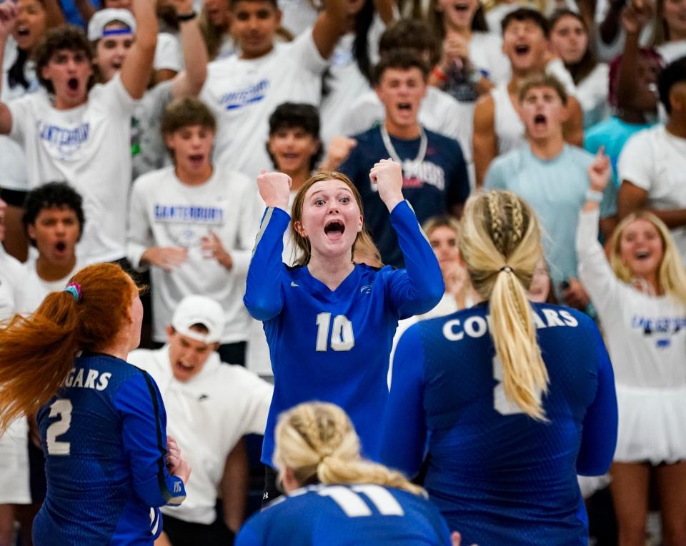 Canterbury Cougars outside hitter Madison Hammermeister (10) and the rest of the team celebrate winning the first set against the Estero Wildcats during a preseason jamboree at the Canterbury School in Fort Myers on Tuesday, Aug. 15, 2023.