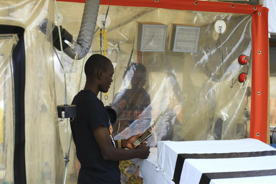 FILE - In this Sunday, Sept 9, 2018 file photo, Kasereka Mulanda, 24, talks with his wife who is suffering from the Ebola virus in an isolation area in Beni, Eastern Congo. The World Health Organization says Ebola deaths in Congo's latest outbreak are expected to exceed 1,000 later on Friday, May 3, 2019. WHO's emergencies chief made the announcement at a news conference in Geneva. The Ebola outbreak that was declared in eastern Congo in August is already the second deadliest outbreak in history, and efforts to control it have been complicated by a volatile security situation and deep community mistrust. (AP Photo/Al-hadji Kudra Maliro, File)