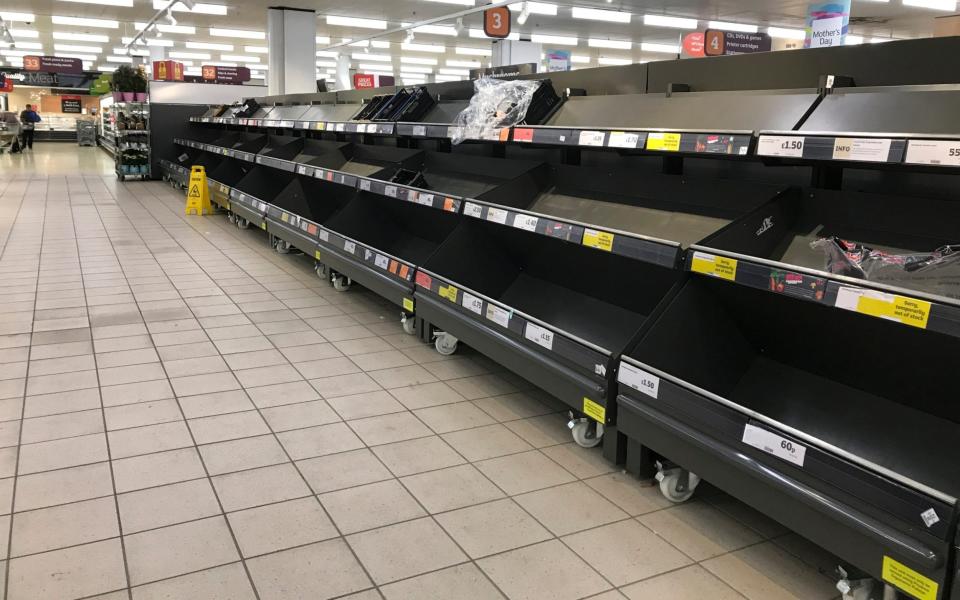 A photo from March of empty shelves in a supermarket - Kirsty Wigglesworth/AP